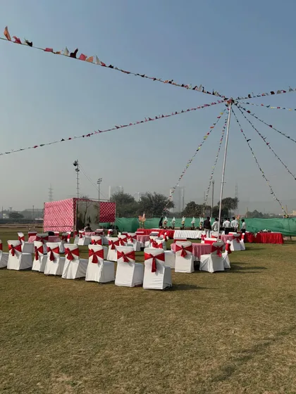 A wide view of the event space, decorated with flags and seating for a large birthday party. My venue can comfortably host groups of all sizes.
