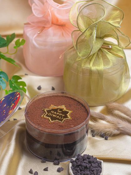 Scoop into the joy of Diwali with my dream cake. This one is a rich chocolate crunch cake, beautifully packaged in organza bags for a luxurious feel.