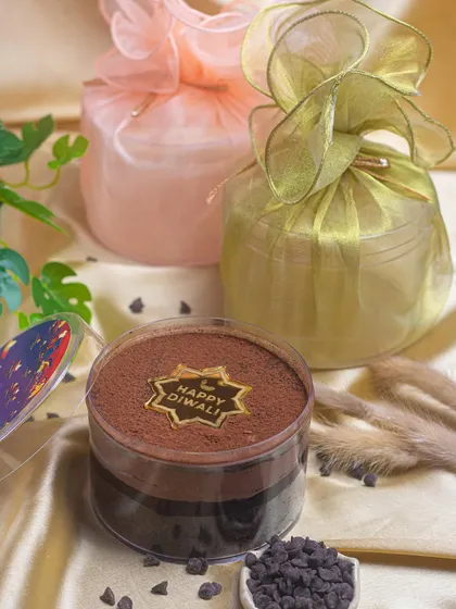 Scoop into the joy of Diwali with my dream cake. This one is a rich chocolate crunch cake, beautifully packaged in organza bags for a luxurious feel.