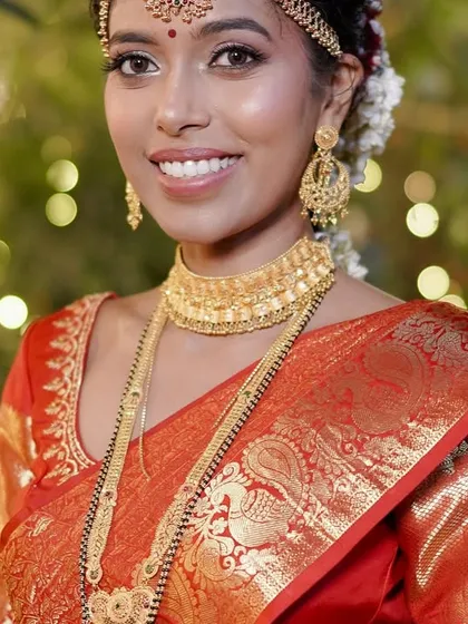 A bride's smile is the best reward. For this South Indian bride, I made sure her red silk saree was pleated to perfection, especially the shoulder pleats, so she would look stunning in her close-up portraits.