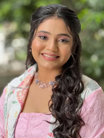 A close-up of her happy face and the subtle glitter details in her makeup.