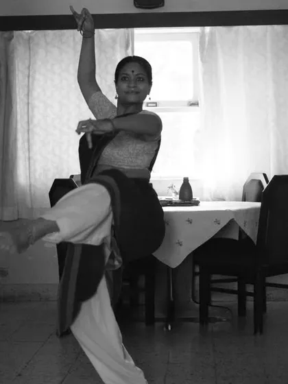 The dynamism of Indian classical dance captured in a single black and white frame. The motion blur conveys the energy of her movement.