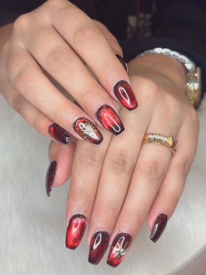 A bold jelly cat eye in a fiery red shade with chrome sunburst accents.