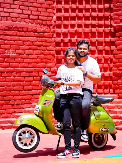 A fun and colorful shot with a vintage-style green scooter. Props like these add a playful element to your pre-wedding photoshoot.