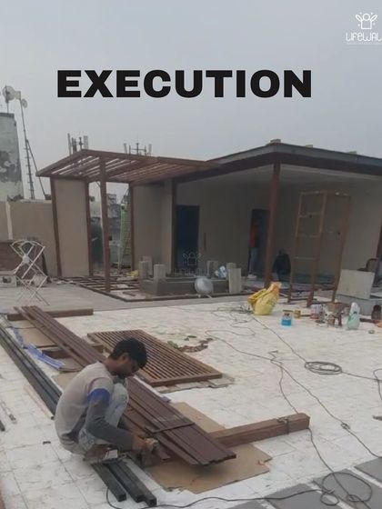 The "Execution" phase of a glass house and pergola project. This photo shows the structures being built and materials being prepared on site.