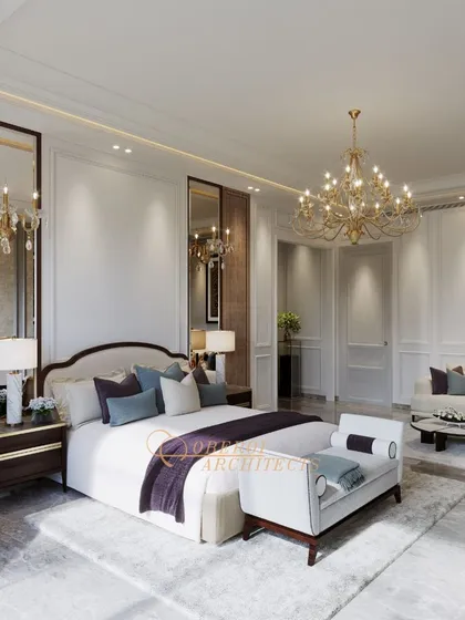 Experience the ultimate in luxury living with this expansive master suite, featuring classic wall paneling, a grand chandelier, and a separate seating area.