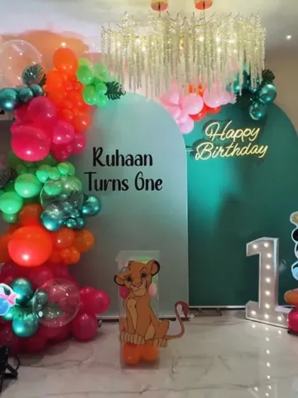 A jungle-themed decoration designed for a home celebration. This setup for Ruhaan's first birthday shows how we can bring big themes to smaller spaces, featuring characters from Winnie the Pooh and The Lion King.