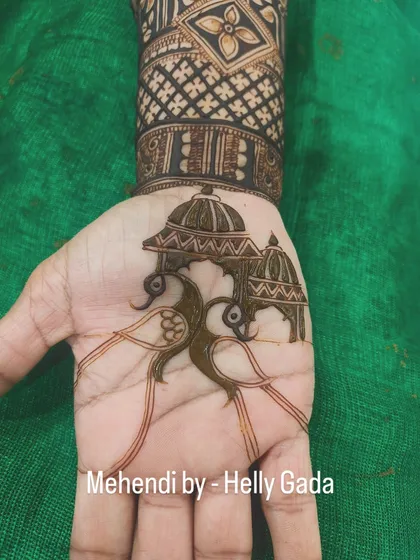 The peacock outline is now filled, creating a simple yet striking design in the center of the palm. This is perfect for siders or a small occasion.