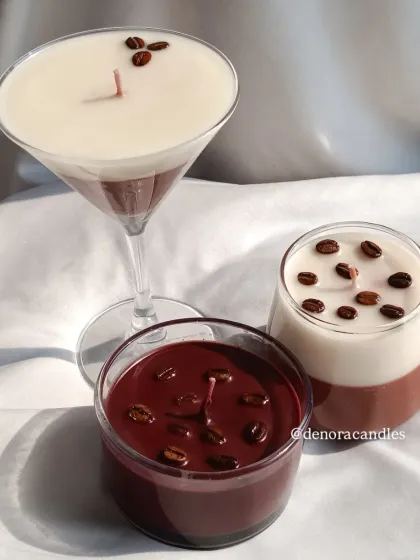 My coffee-themed candle collection includes various styles. You can choose from a layered martini glass, a two-toned glass, or a dark roast style, all topped with real coffee beans.