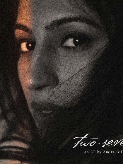 The EP cover for Amira Gill's 'two.seven'. This intense black and white close-up, with a sliver of warm light, captures the soulful and personal nature of her music.