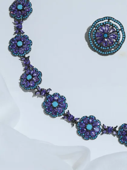 A detailed flat lay of the Amethyst and Turquoise necklace and one earring, emphasizing the contrast and harmony of the gemstones.