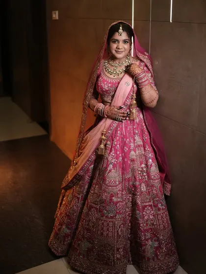 This bride looks absolutely regal in her pink lehenga. The makeup is soft and glowing, with a focus on enhancing her natural features.