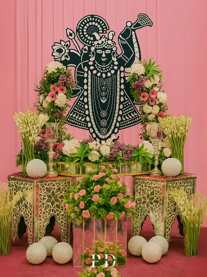 We incorporate personal and spiritual elements into our designs. This custom Shrinathji installation, framed by fresh flowers, served as a divine focal point for the wedding ceremony.