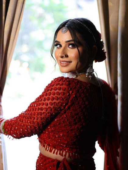 A beautiful smile from the bride as she turns back. This shot captures her happiness and the flawless finish of her makeup, which looks perfect from every angle.