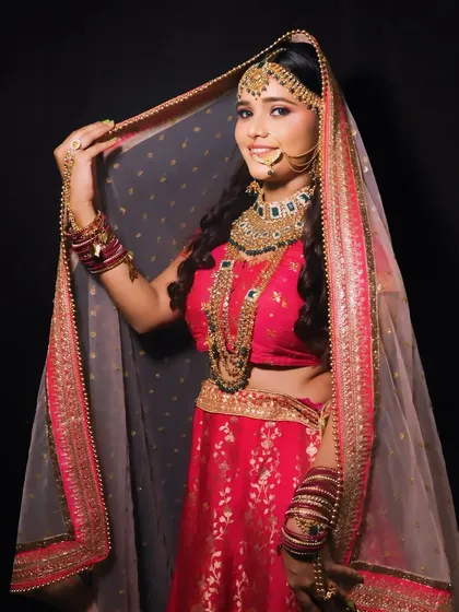 A full-length shot of the bride holding her veil. This gives a great idea of the entire ensemble and how the makeup and hair tie it all together.