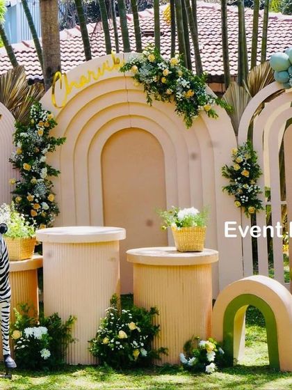 Another angle of Charvik's stylish safari party, showing the arrangement of the ribbed pedestals, animal props, and the elegant balloon garland. The attention to texture and color creates a sophisticated look.