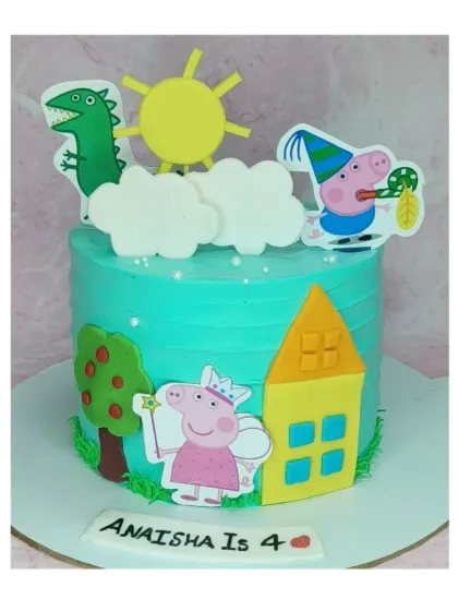 This simple and sweet Peppa Pig cake is a choco-chip flavor. It shows Peppa and George playing outside their house under a bright sun, perfect for a young fan.