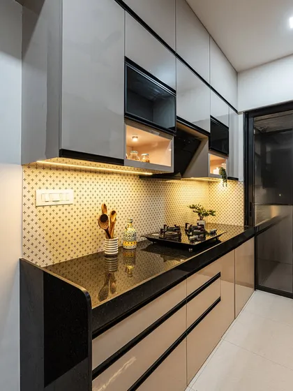 The patterned backsplash tiles add a touch of personality to this otherwise neutral kitchen. The black granite countertop is durable and easy to maintain, which is a priority for my clients.