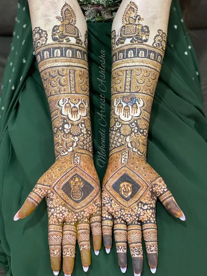A complete bridal mehendi design featuring figures of a bride and groom on an elephant. The palms also have personalized symbols, making it a unique piece of art.