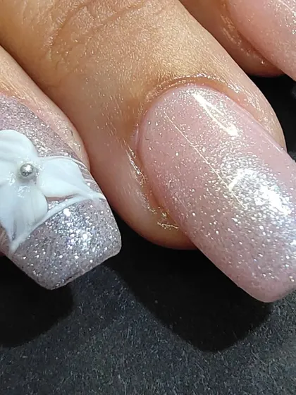 A close-up of the hand-sculpted 3D flower with a silver bead center.