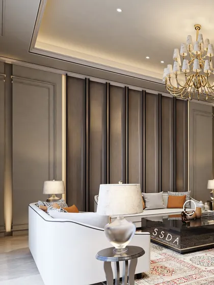 A view of the formal living room where neoclassical mouldings and a fluted wall panel create a backdrop of texture and refinement. The ornate chandelier adds a touch of classic glamour to the modern space.