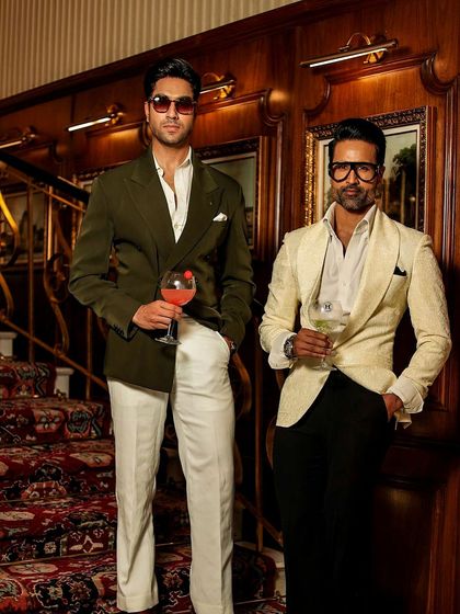 A showcase of our blazer designs. An olive green double-breasted blazer and a textured ivory jacket, both handcrafted for a lifetime of sophisticated dressing.