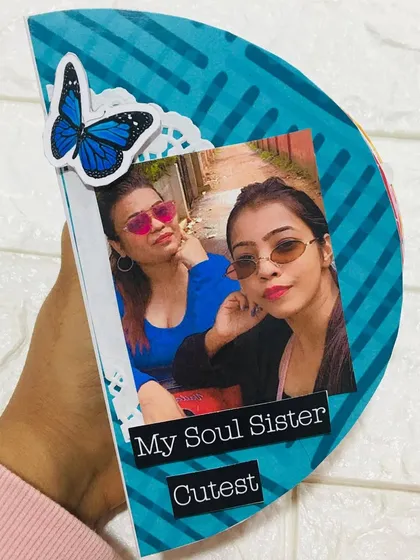 The cover of a semi-circle album, a unique shape for a photo book. This one was made for Raksha Bandhan to celebrate a soul sister.