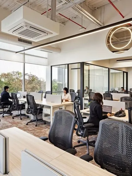 An open and flexible workspace at CorporatEdge, Bangalore. The generous use of glass for partitions brings in natural light and reduces barriers, fostering a culture of collaboration and transparency.