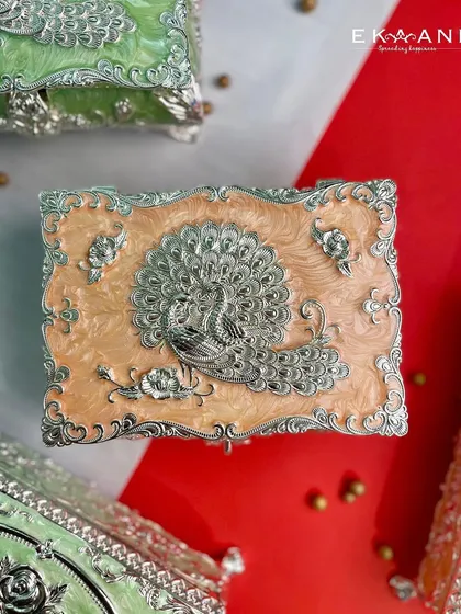 The same exquisite peacock design, this time on a warm peach enamel box. The soft pastel shades of this collection offer a blend of utility and elegance for your home.