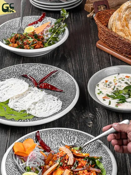 I love bringing authentic regional flavors to my guests. This spread features classic dishes from Kerala, like Idiyappam and Mutton Ularthiyathu, offering a true taste of the coast.