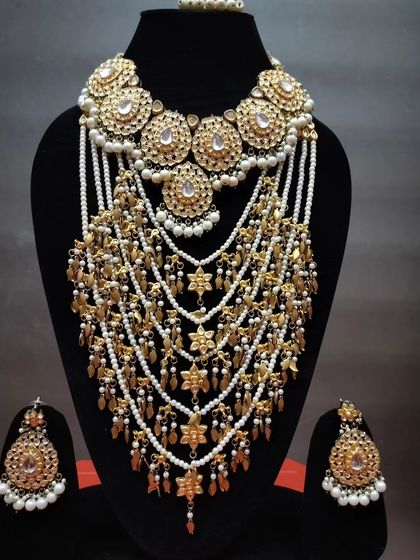 A majestic, multi-layered 'Satlada' haar with Kundan and pearl work, designed for a truly royal bride.