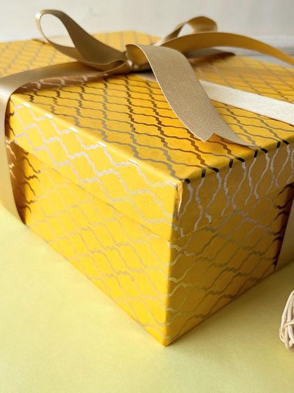 Our Diwali hamper comes in this beautiful and sturdy yellow box, tied with a golden ribbon.