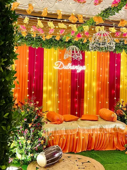 A lively Dholki setup for the bride-to-be. The colorful drapes and 'Dulhaniya' neon sign set the stage for a night of music, laughter, and celebration.