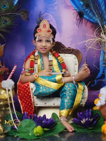 A majestic portrait from a 'Little Krishna' themed photoshoot. The elaborate costume, crown, and divine setup create a stunning image for Janmashtami or any special occasion.