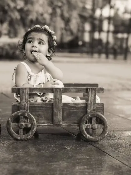 A timeless black and white portrait from an outdoor shoot in Thane. The focus is purely on the child's expression and the beautiful, natural surroundings.