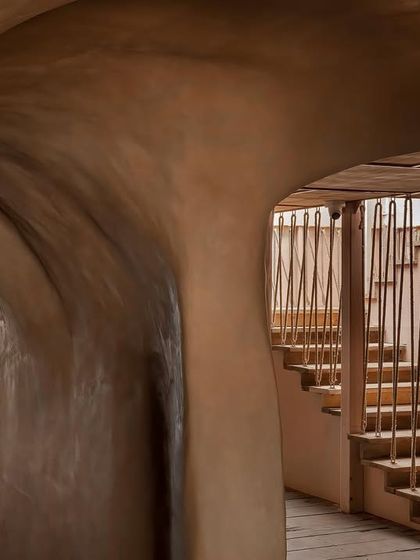 A detail of the staircase at Dubki, featuring a unique railing made of suspended ropes. This element adds to the rustic, nautical theme while maintaining a sense of openness and light.