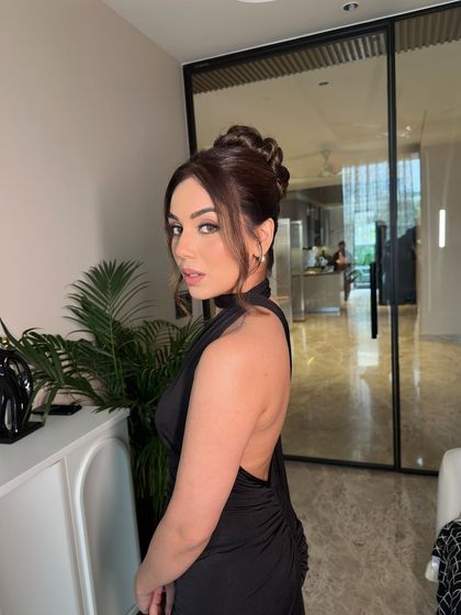 The final look, where the dramatic topknot perfectly complements the backless dress.