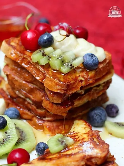 A bright and appetizing shot of french toast topped with fresh fruit. This is a great example of the quality food photography our network provides for cafes, food bloggers, and culinary brands.