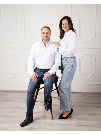A modern and clean portrait of a couple. The simple white shirts and jeans create a timeless look that focuses on their connection.