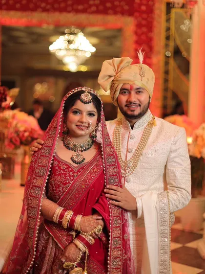 A classic posed portrait of the bride and groom. This is the essential photo that every family wants, captured with beautiful lighting and a rich background.