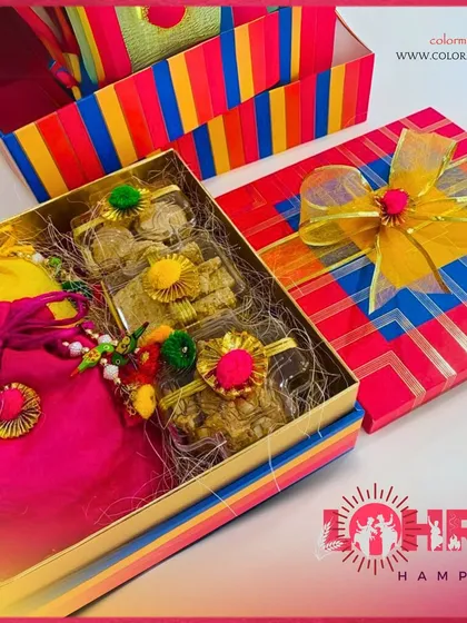Our colorful striped Lohri box is a cheerful and bright gift. It opens to reveal traditional sweets and a pink potli, embodying the joyous spirit of the harvest festival.