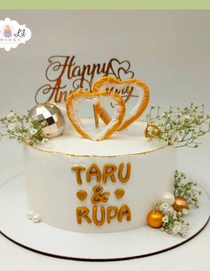 A beautiful anniversary cake for Taru and Rupa, featuring isomalt heart toppers and delicate baby's breath.
