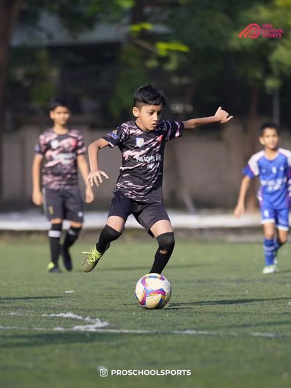 A young player about to make a pass, demonstrating good awareness and technique.