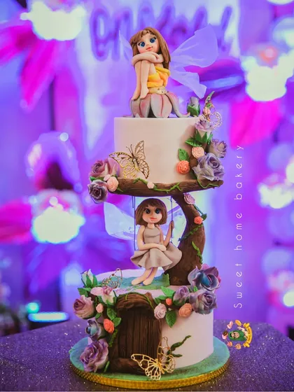 Another view of the magical fairy cake, showing the intricate details of the tree branch and flowers.