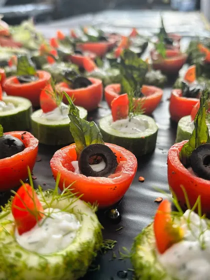 My scooped vegetable salads are both healthy and beautiful. I use hollowed-out cucumbers and tomatoes as edible cups for a creamy dill salad, garnished with black olives.