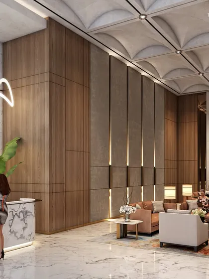 Another view of the South Mumbai lobby, where a sculptural light fixture hangs above the seating area. Every feature radiates elegance, from the stone-clad podiums to the textured towers that pierce the skyline.
