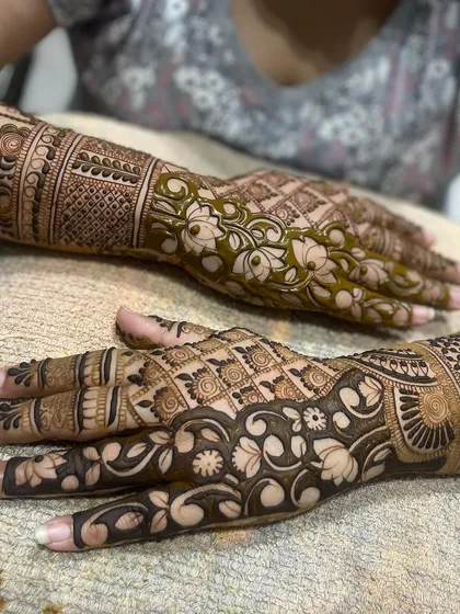 A close-up showing the contrast between a freshly applied henna design and one with a developed stain.