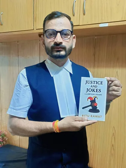 A formal photo with the book "Justice and Jokes." I encourage everyone to support the work of writers within our legal fraternity.