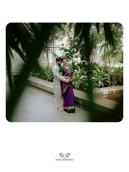 An intimate portrait of the couple embracing, framed by lush greenery for a private, romantic feel.