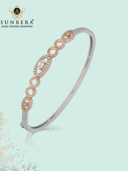 A chic two-tone kada bracelet in silver and rose gold. The geometric links and sparkling accents make it a modern and stylish accessory.